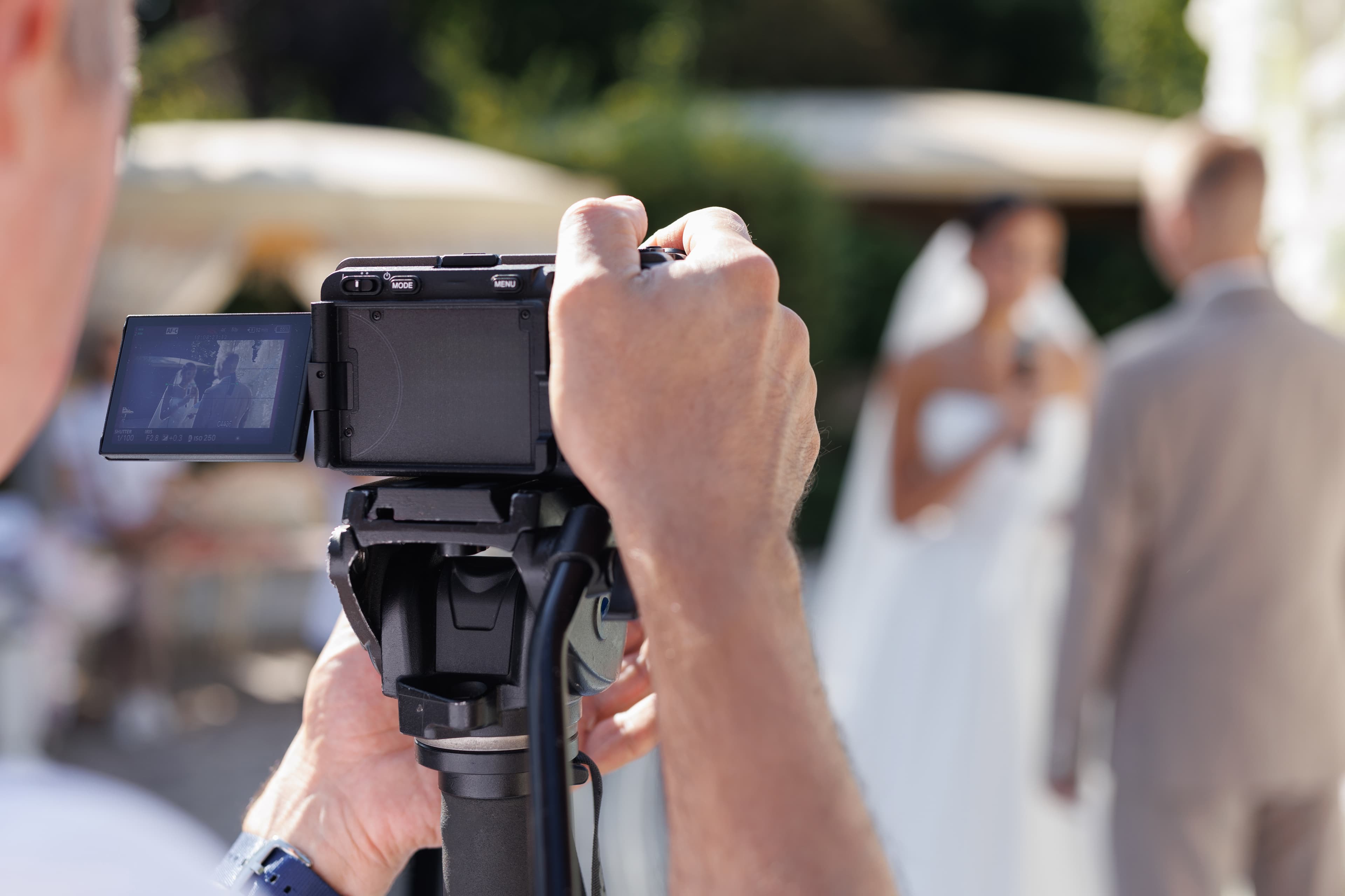 Professional videographer capturing wedding moments