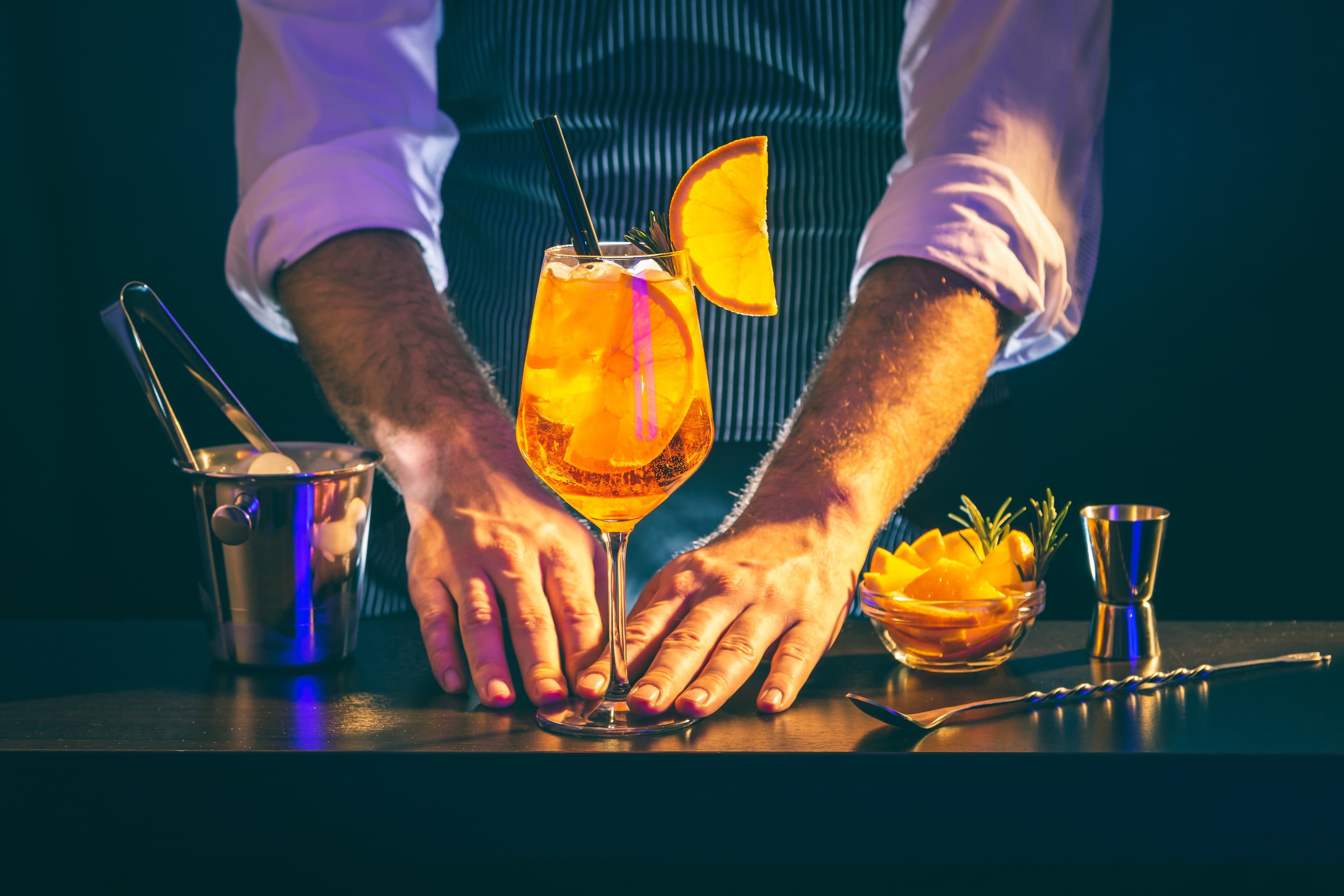 Professional bartender serving craft cocktails